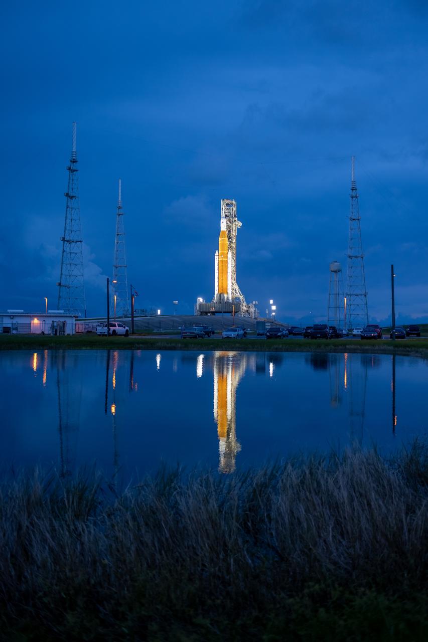 NASA’s Space Launch System (SLS) rocket with the Orion spacecraft aboard is seen atop the mobile launcher at Launch 39B at NASA’s Kennedy Space Center in Florida. Artemis I mission is the first integrated test of the agency’s deep space exploration systems: the Space Launch System rocket, Orion spacecraft, and supporting ground systems. The mission is the first in a series of increasingly complex missions to the Moon. Launch of the uncrewed flight test is targeted for no earlier than Sept. 3 at 2:17 p.m. ET. With Artemis missions, NASA will land the first woman and first person of color on the Moon, using innovative technologies to explore more of the lunar surface than ever before. Photo Credit: (NASA/Jared Lyons)